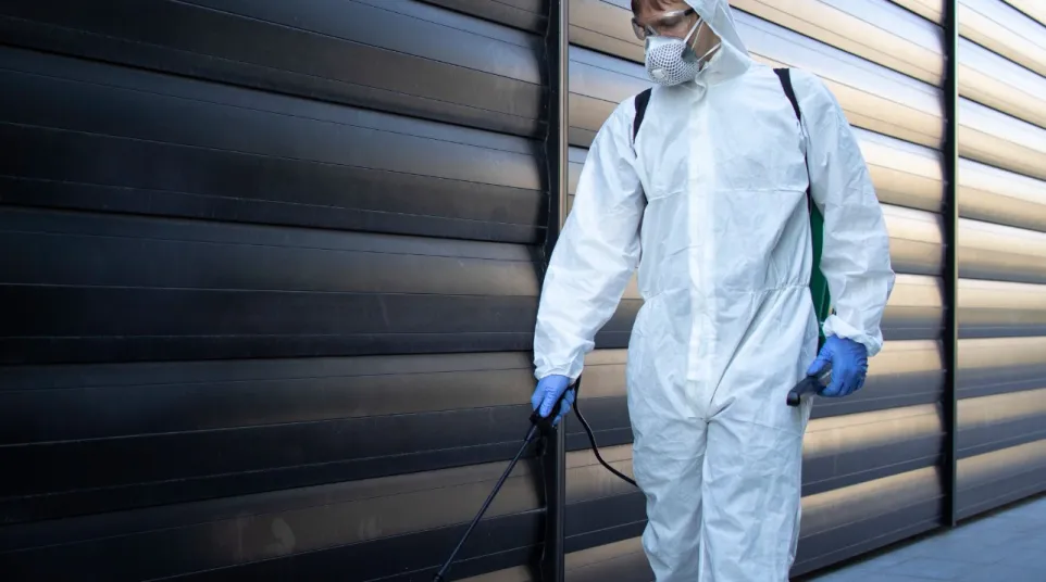 a person in a white lab coat and mask holding a cane