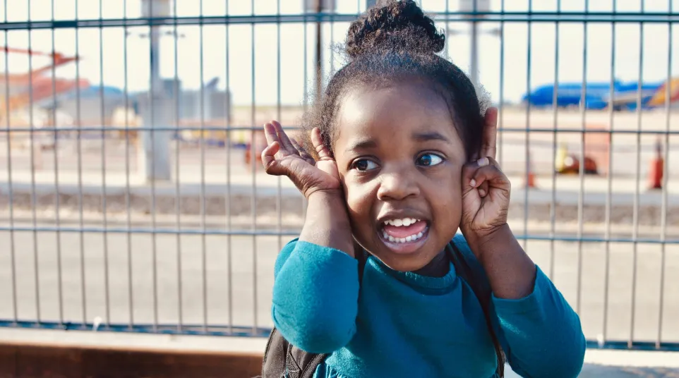 a girl with her hands on her head