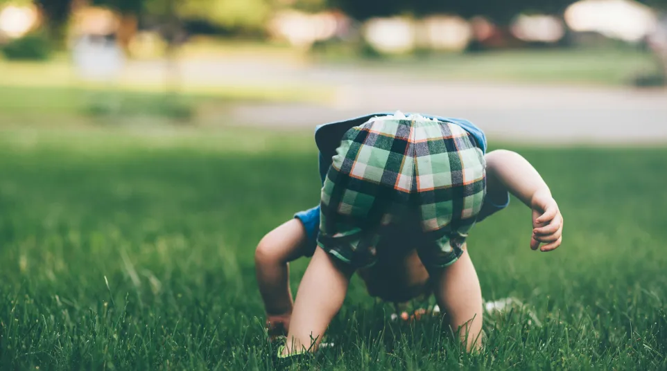 a person kneeling in grass