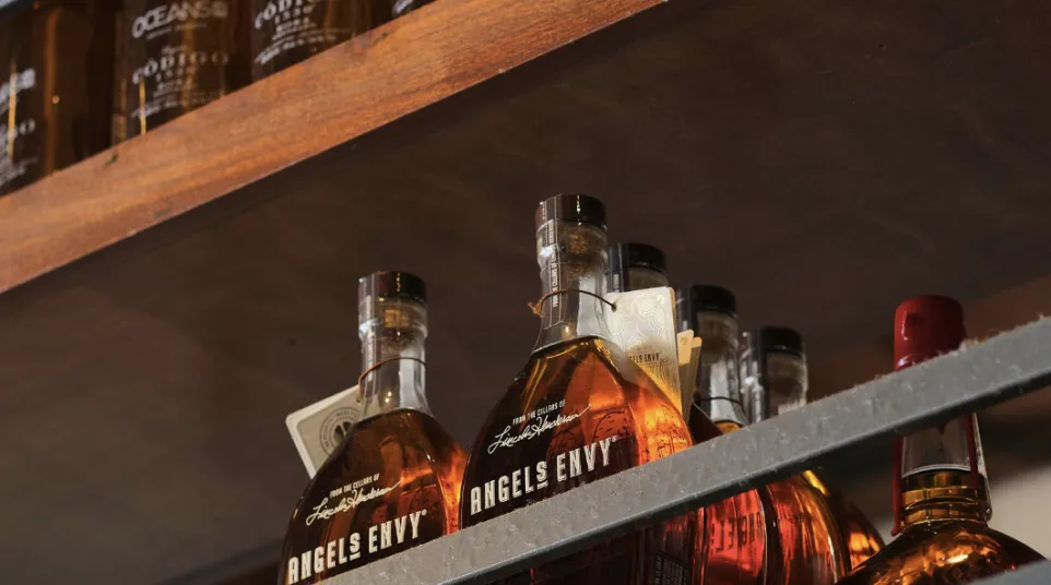 a shelf with bottles of alcohol on it