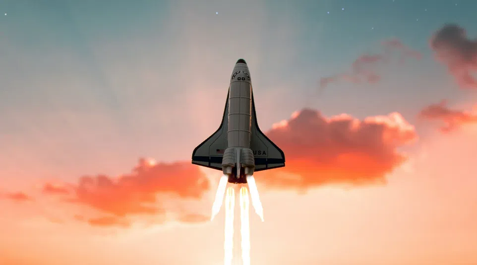Space shuttle launching at sunset with fiery exhaust trails under a starry sky and a bright meteor.