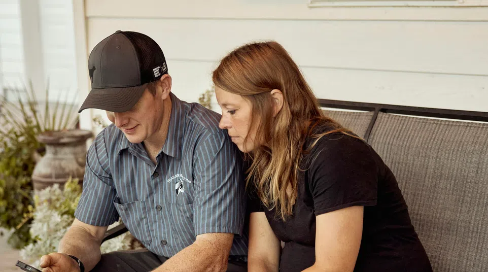 Service technician reviewing details with a homeowner on her front porch