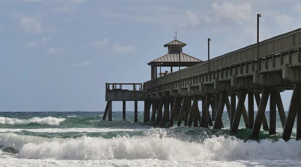 a pier with waves crashing against it