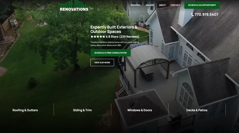 Aerial view of a renovated home exterior with deck, pergola, and green lawn surrounded by trees.