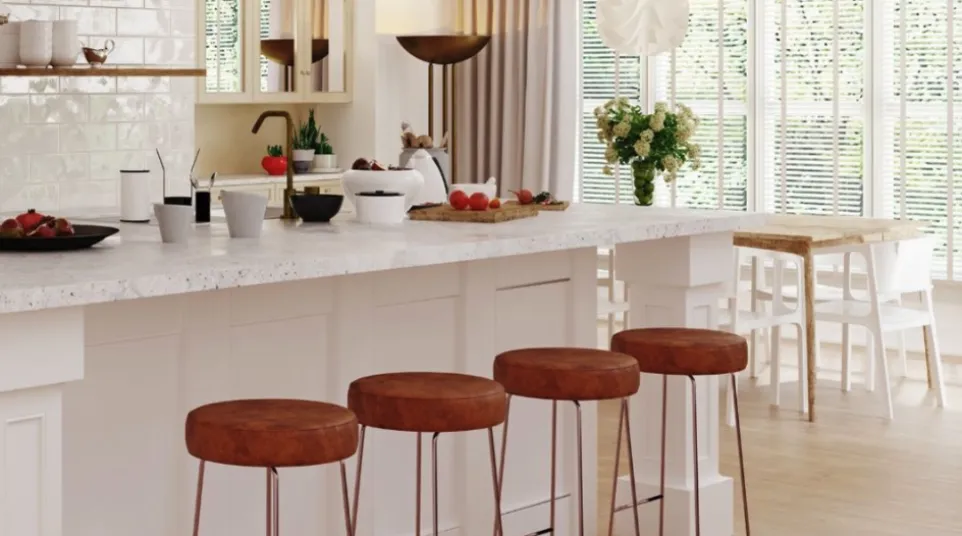 Modern kitchen island with white marble countertop and four brown leather bar stools in spacious dining area.