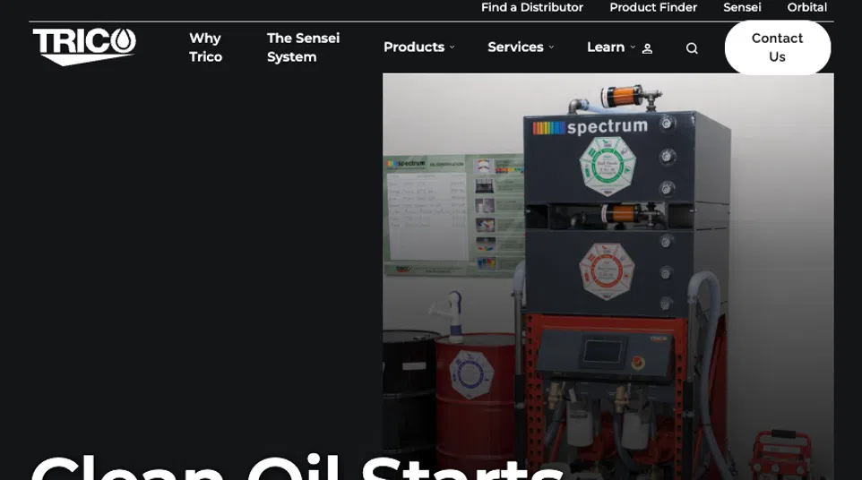 Industrial oil filtration system labeled Spectrum with drums and control panel in a clean facility setting.