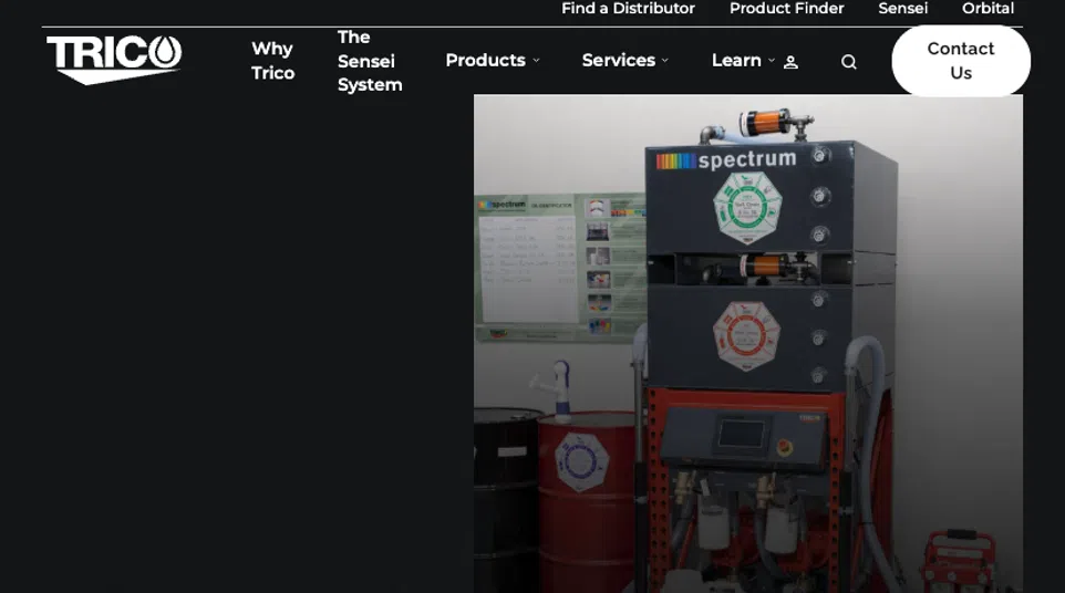 Industrial oil filtration system with labeled barrels and control panel for clean lubricant storage and processing.
