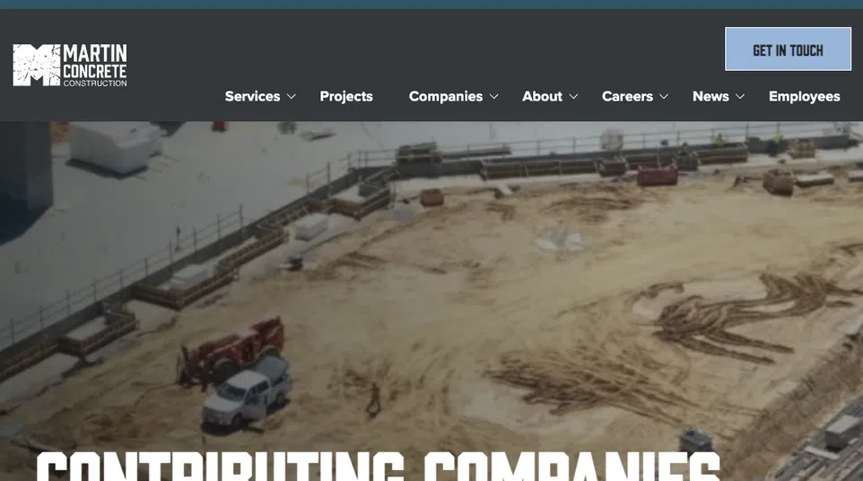 Construction site with vehicles and foundation work showcasing contributing companies in concrete construction.