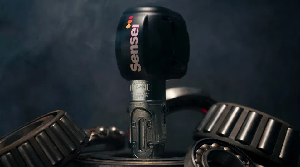 Sensei tattoo machine motor surrounded by metallic bearings with smoky dark background atmosphere