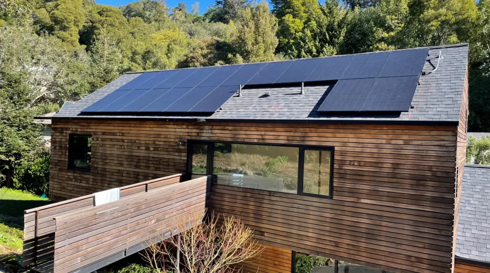 a house with a deck and trees in the back