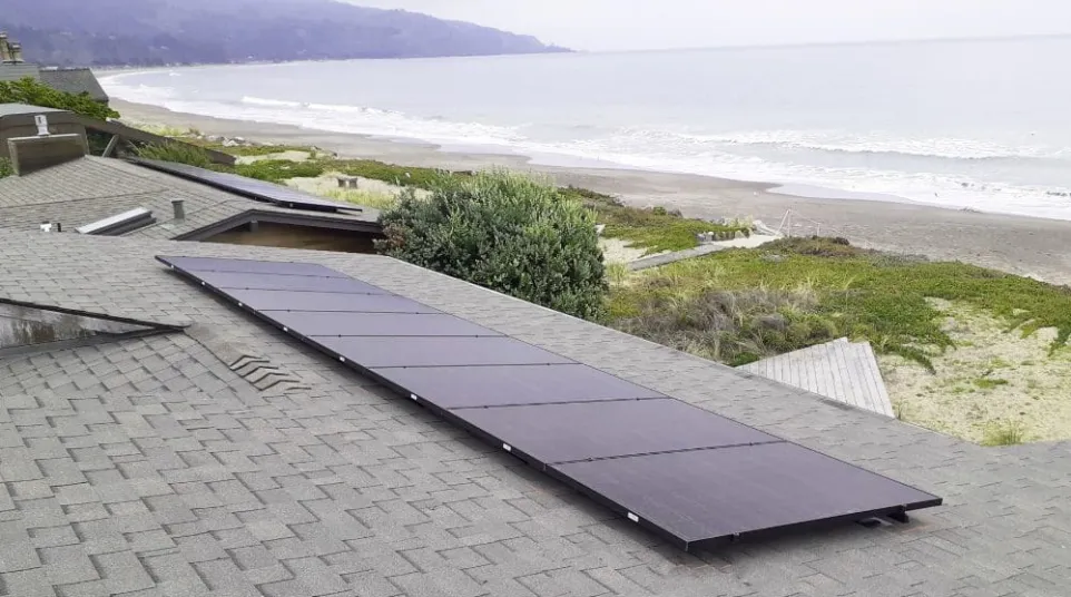 a roof with a solar panel on it by a beach