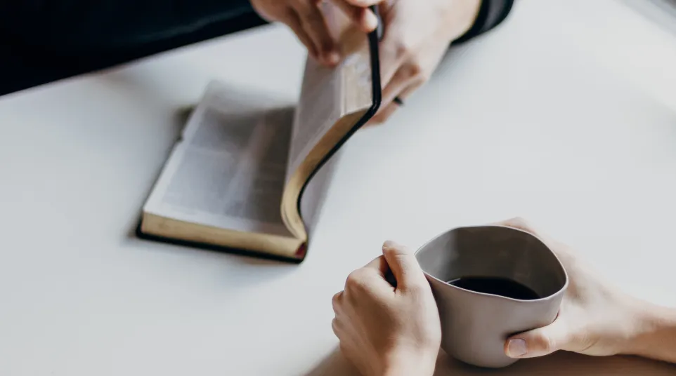 couple reading scripture at the table with coffee