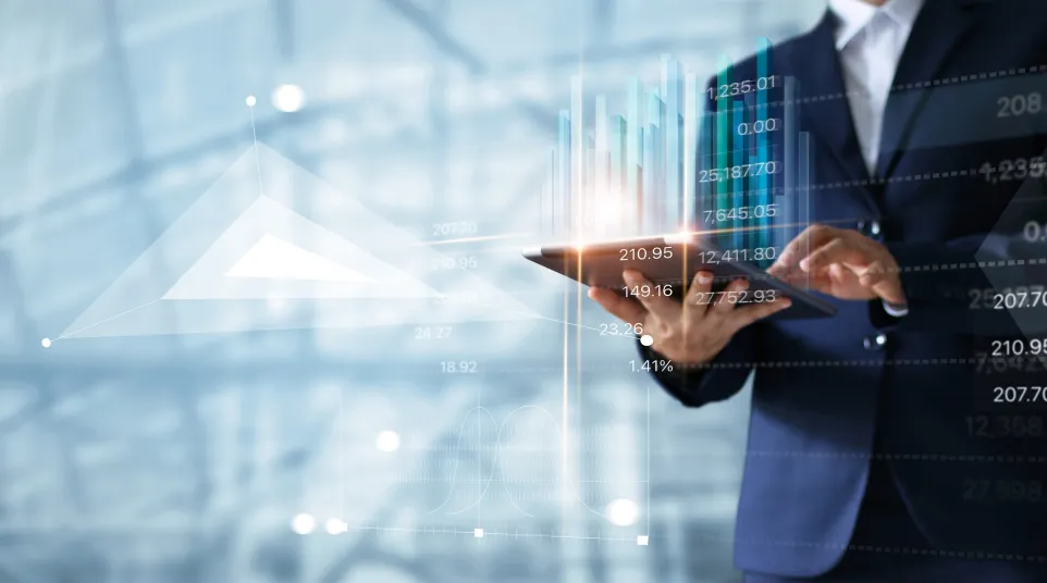 Business professional analyzing digital financial data on a tablet with graphs and trends.