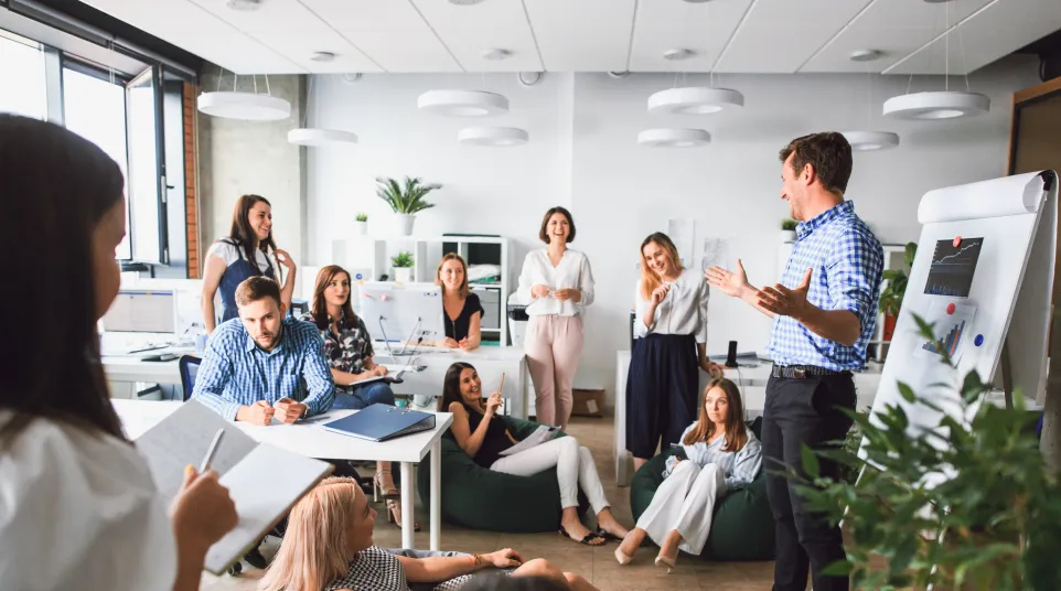 A dynamic office meeting with diverse professionals engaged in a discussion.