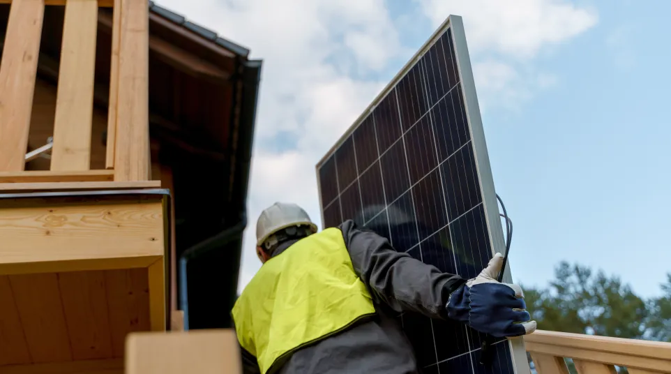 a person wearing a hard hat and protective gear working on a roof