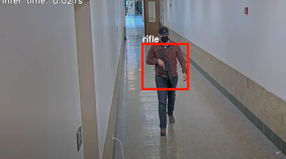 a person in a garment walking down a hallway