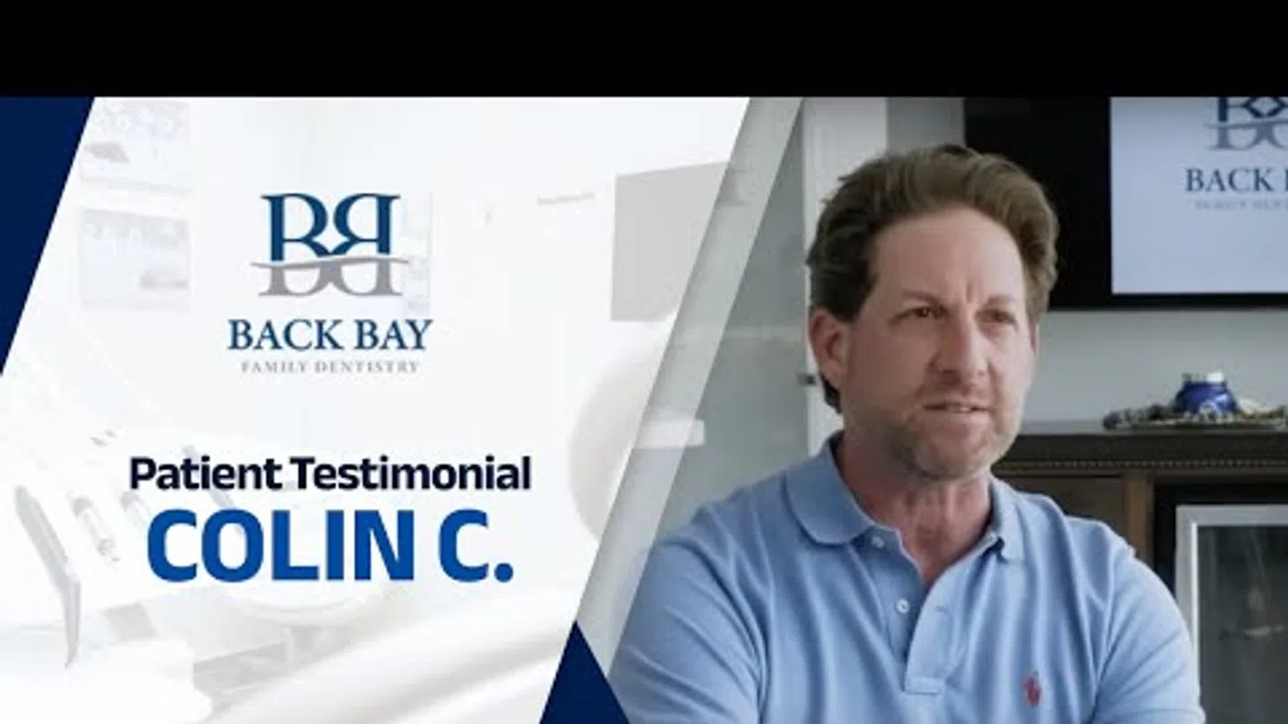 Patient testimonial from Colin C at Back Bay Family Dentistry with dental office background.
