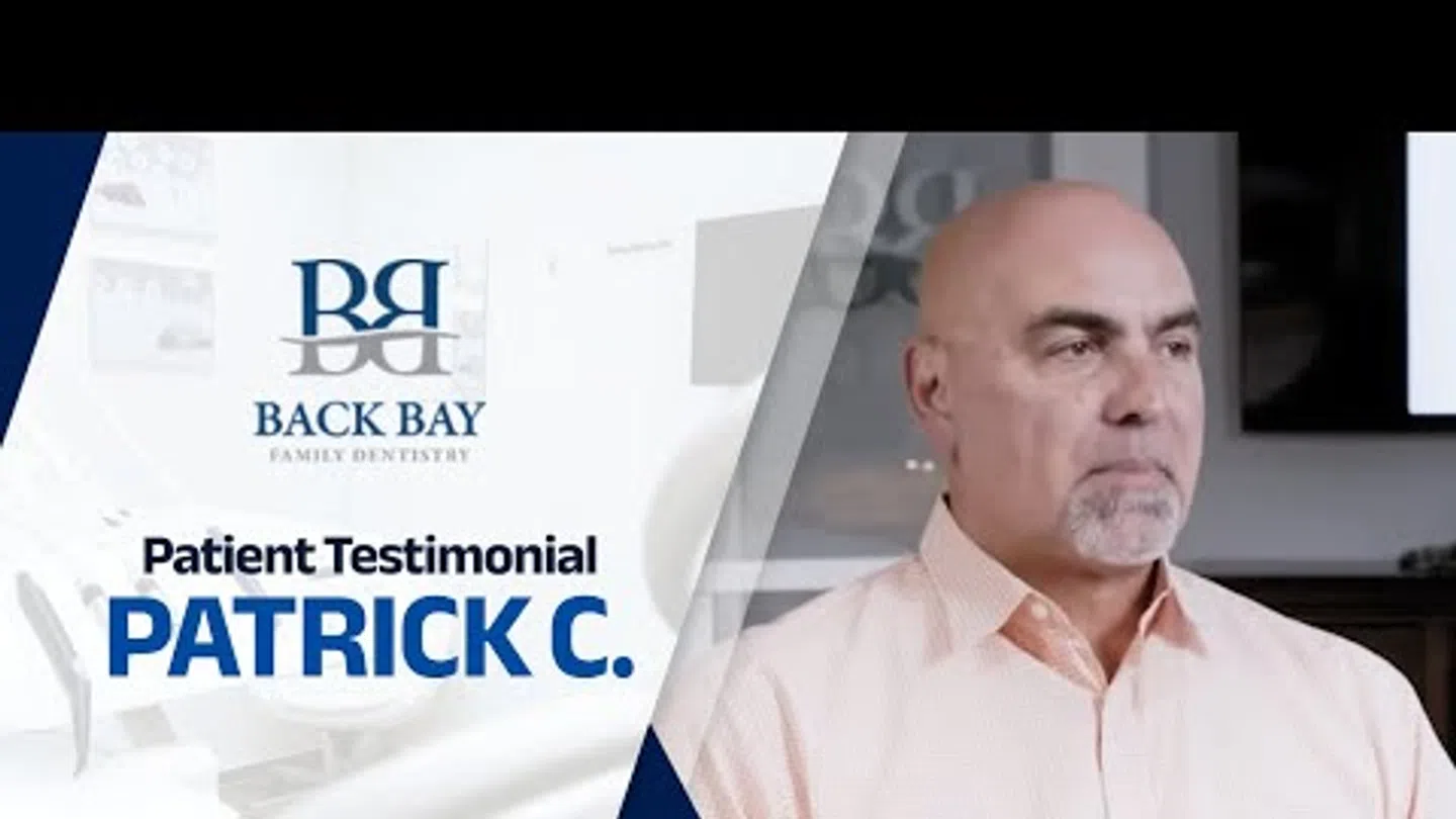 Middle-aged man giving a testimonial for Back Bay Family Dentistry in a professional setting.
