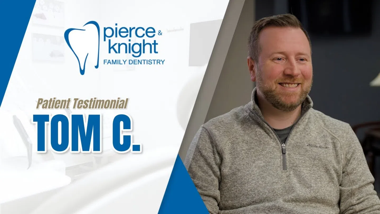 Smiling man in gray sweater shares patient testimonial for Pierce & Knight Family Dentistry.