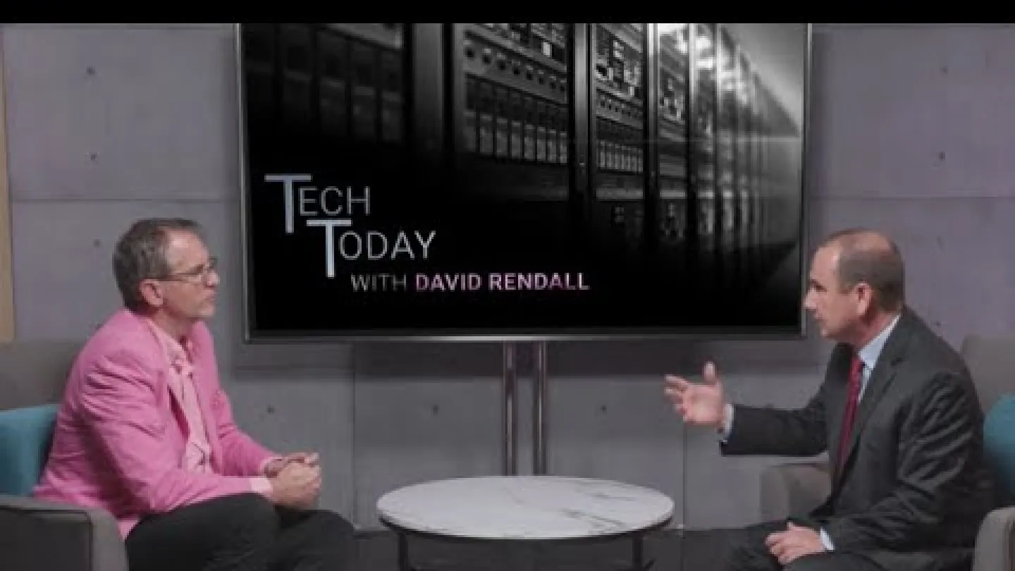 Two men discuss technology on the Tech Today with David Rendall show in a modern studio setting.