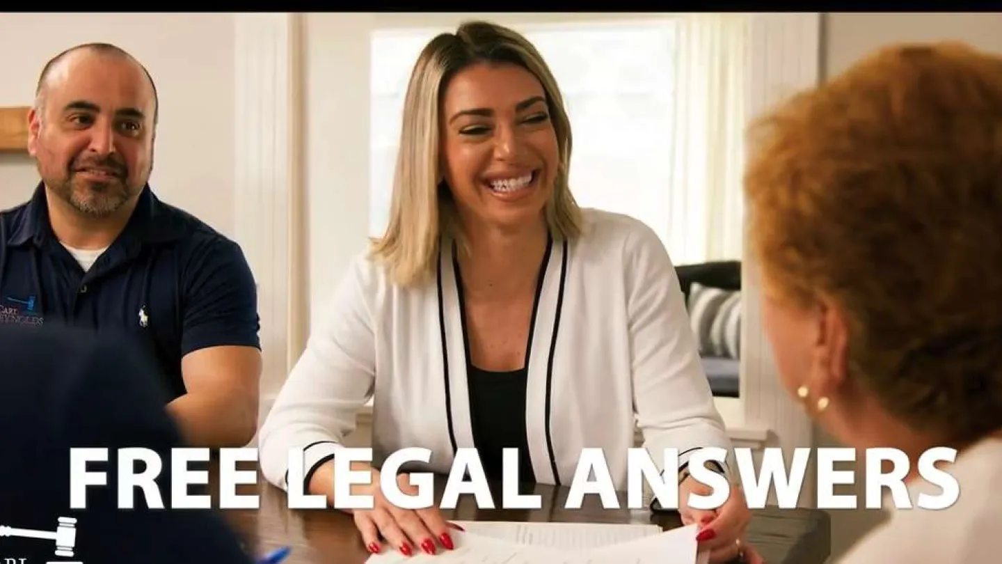 Smiling female lawyer providing free legal answers to clients in a professional office setting.