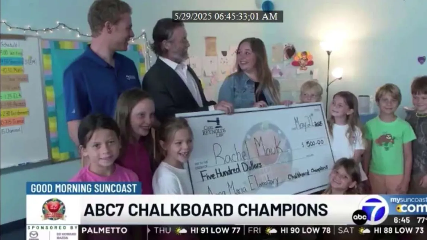 Teacher Rachel Mauk receives a $500 check as ABC7 Chalkboard Champions celebrate with smiling elementary students.