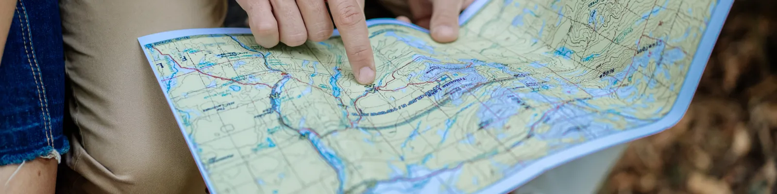 A group of people referring to a Printed Map