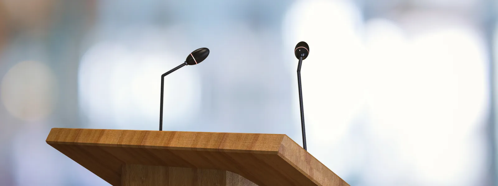 a wooden podium with two microphones on top