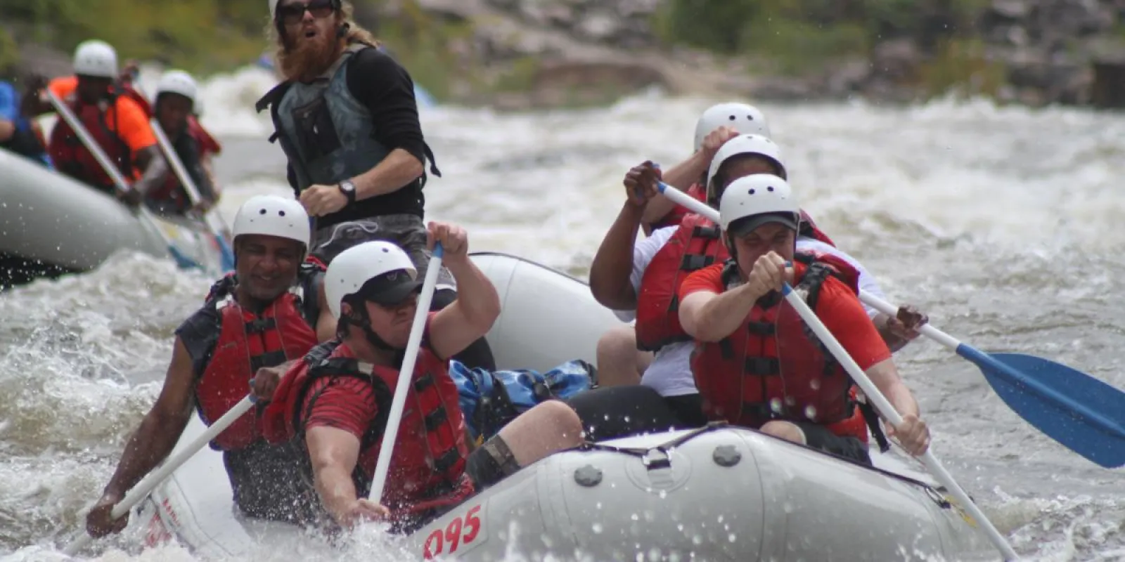 a group of people riding on a raft in a body of water