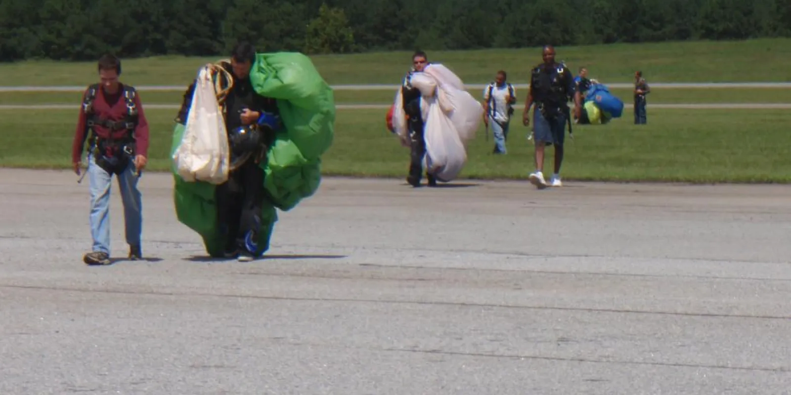 a group of people walking back from sky diving