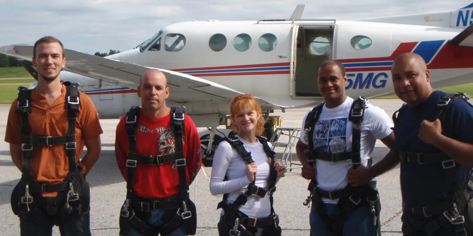 a group of people standing around a plane