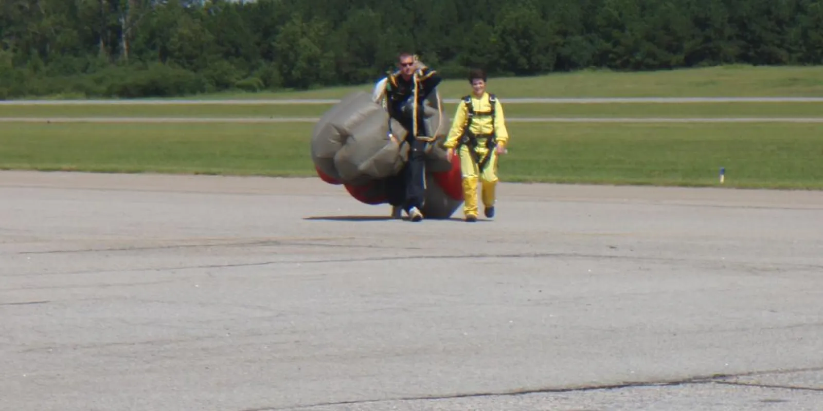 two people walking back from sky diving