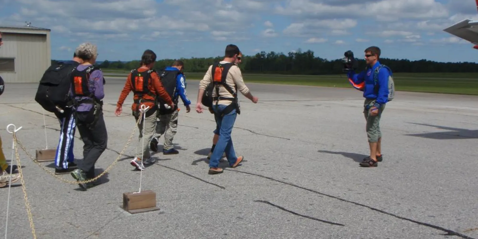 a group of people standing on a runway
