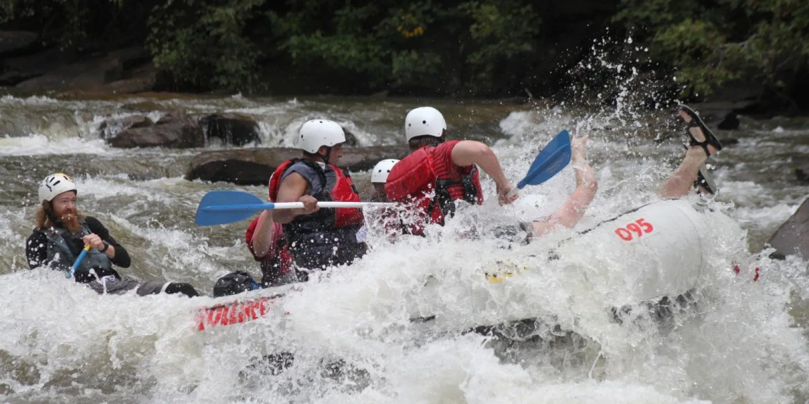 a group of people riding on a raft in a body of water