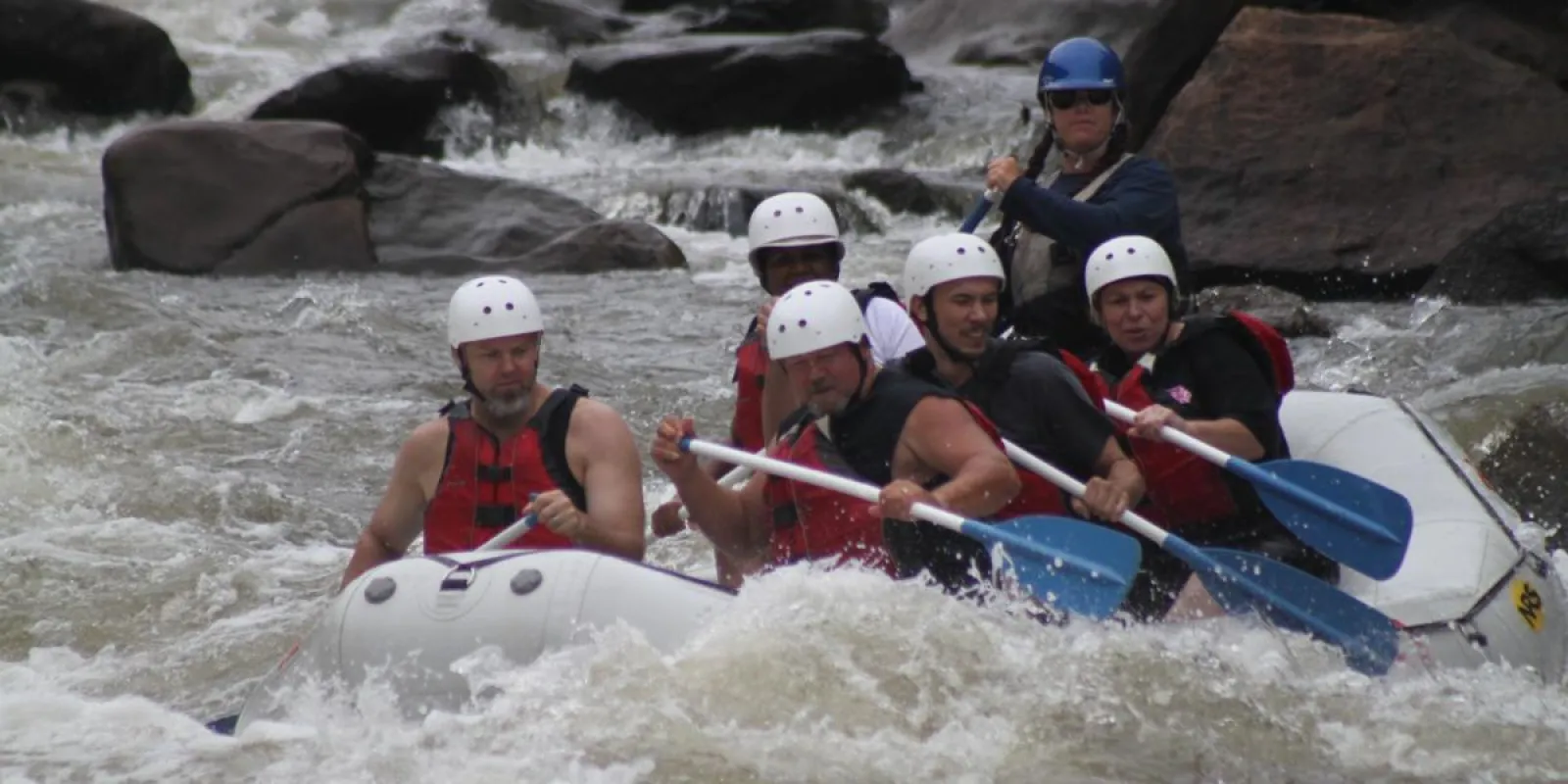 a group of people on a raft in a body of water