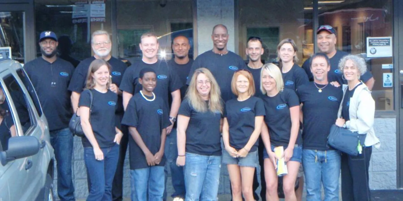 a group of people posing for a photo in front of a building