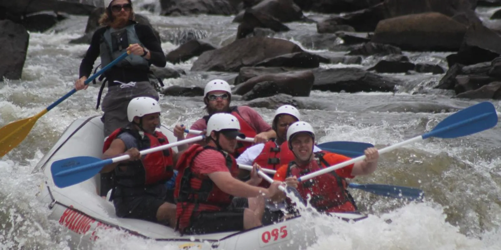 a group of people riding on a raft in a body of water