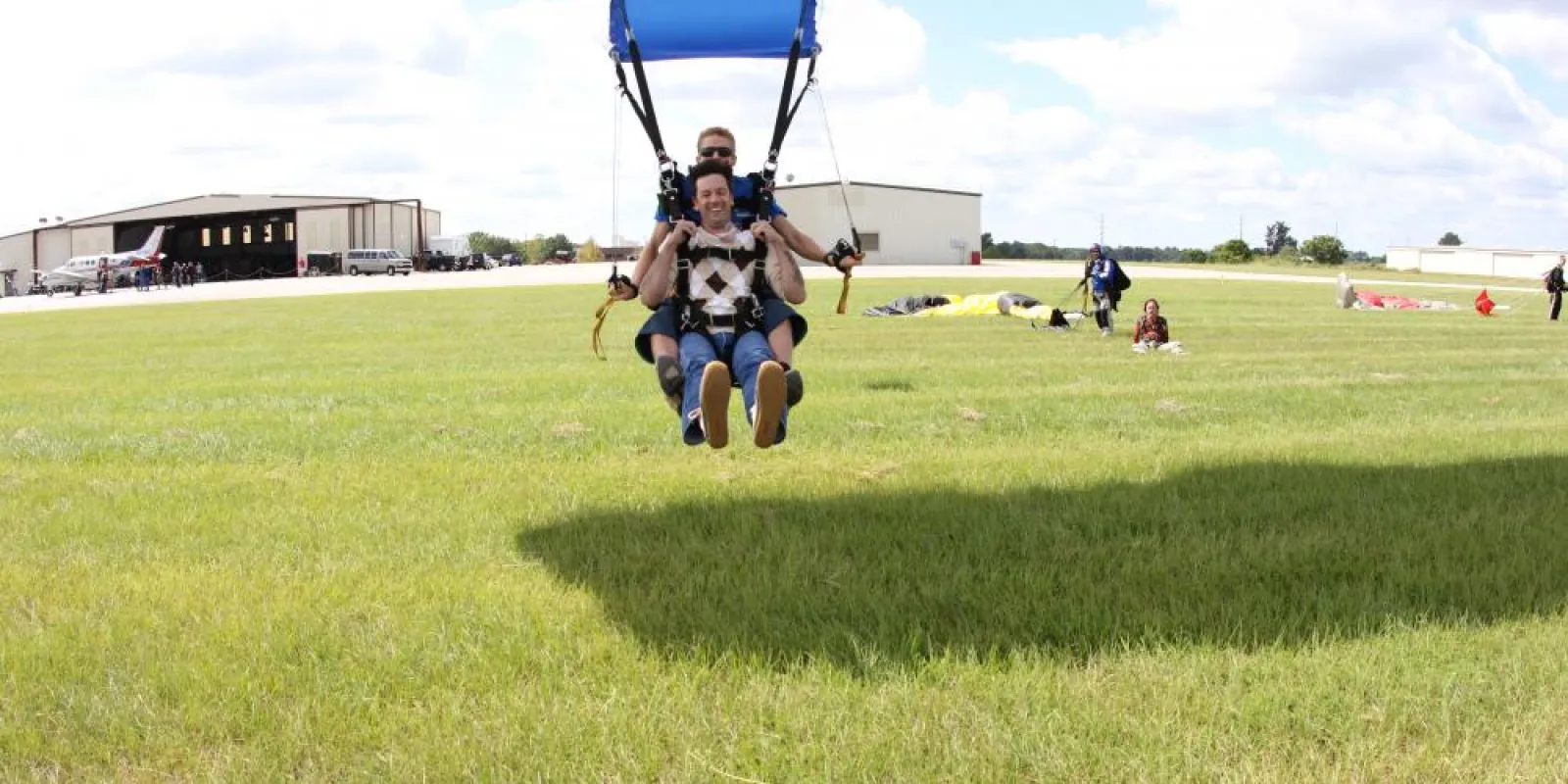 a group of people landing after sky diving