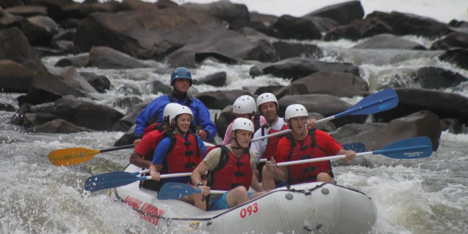 a group of people on a raft in a body of water