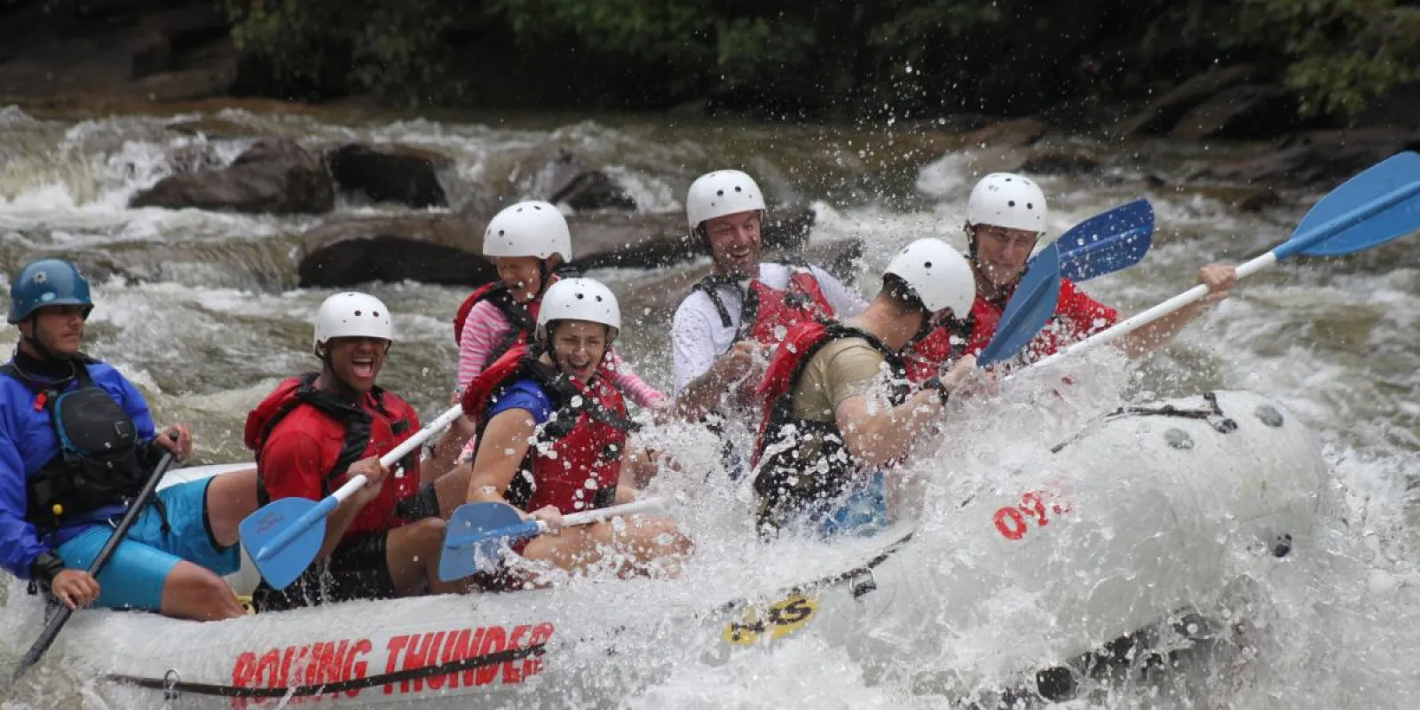 a group of people riding on a raft