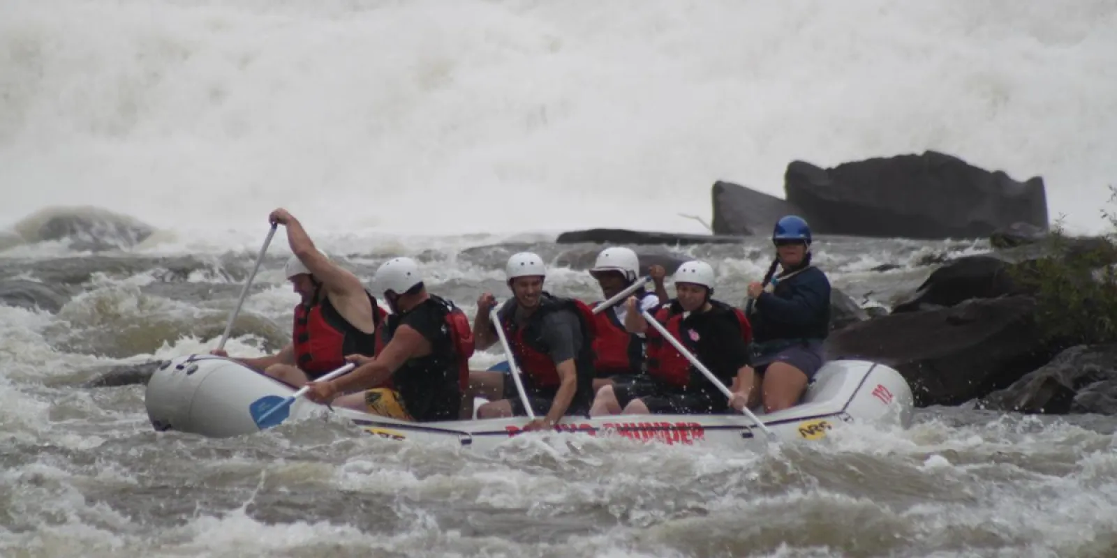 a group of people on a raft in the water