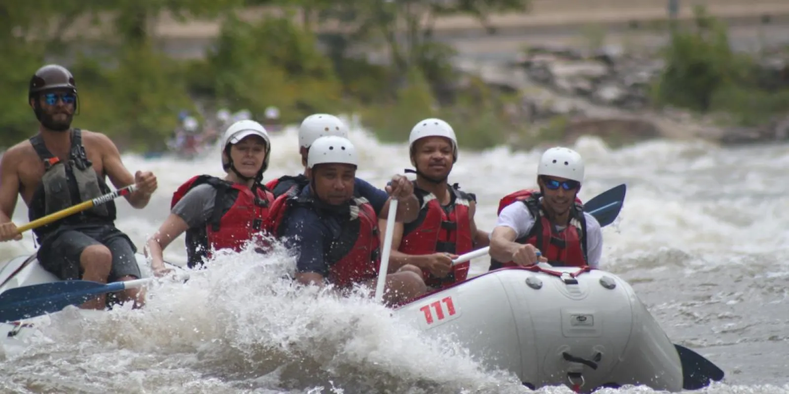 a group of people riding on a raft in the water