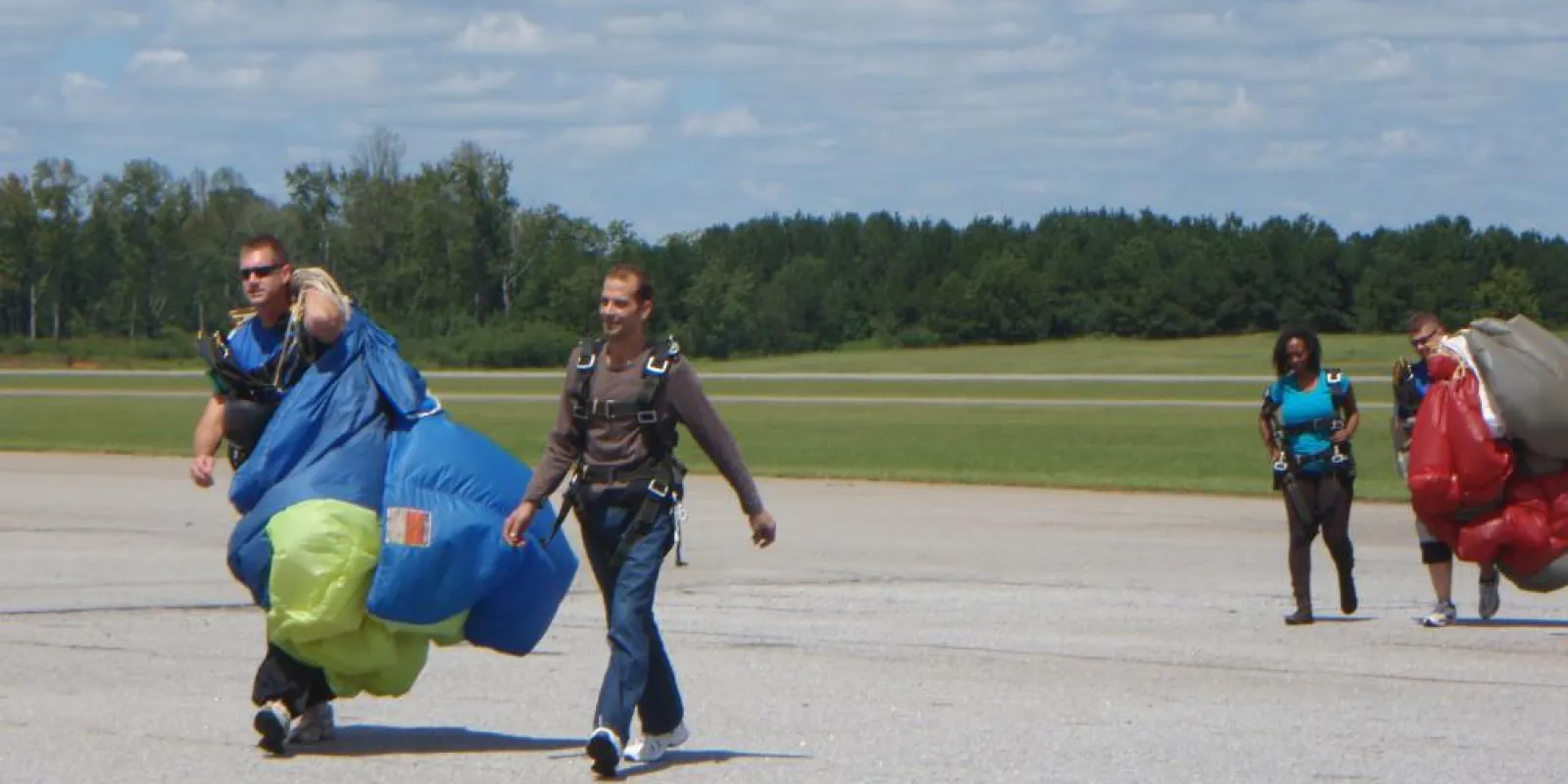a group of people walking back from sky diving