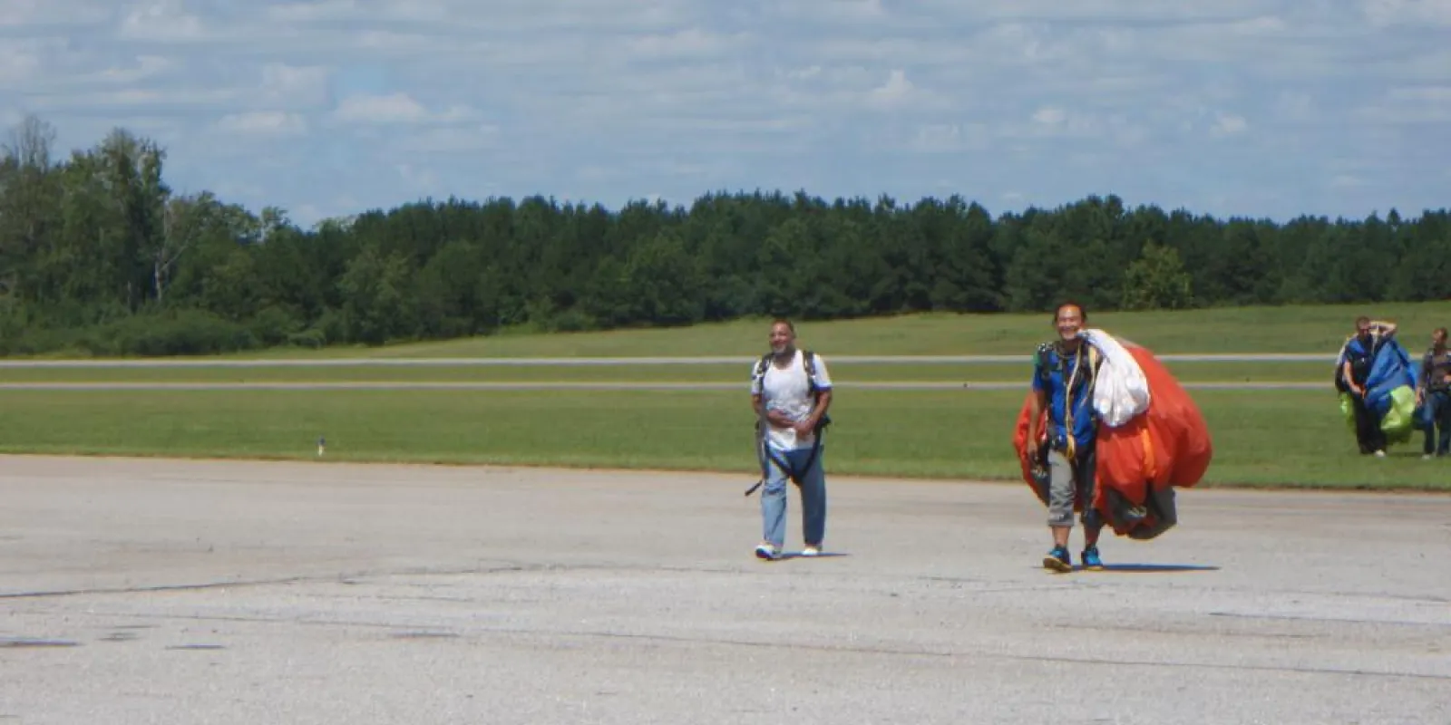 a group of people walking back from sky diving