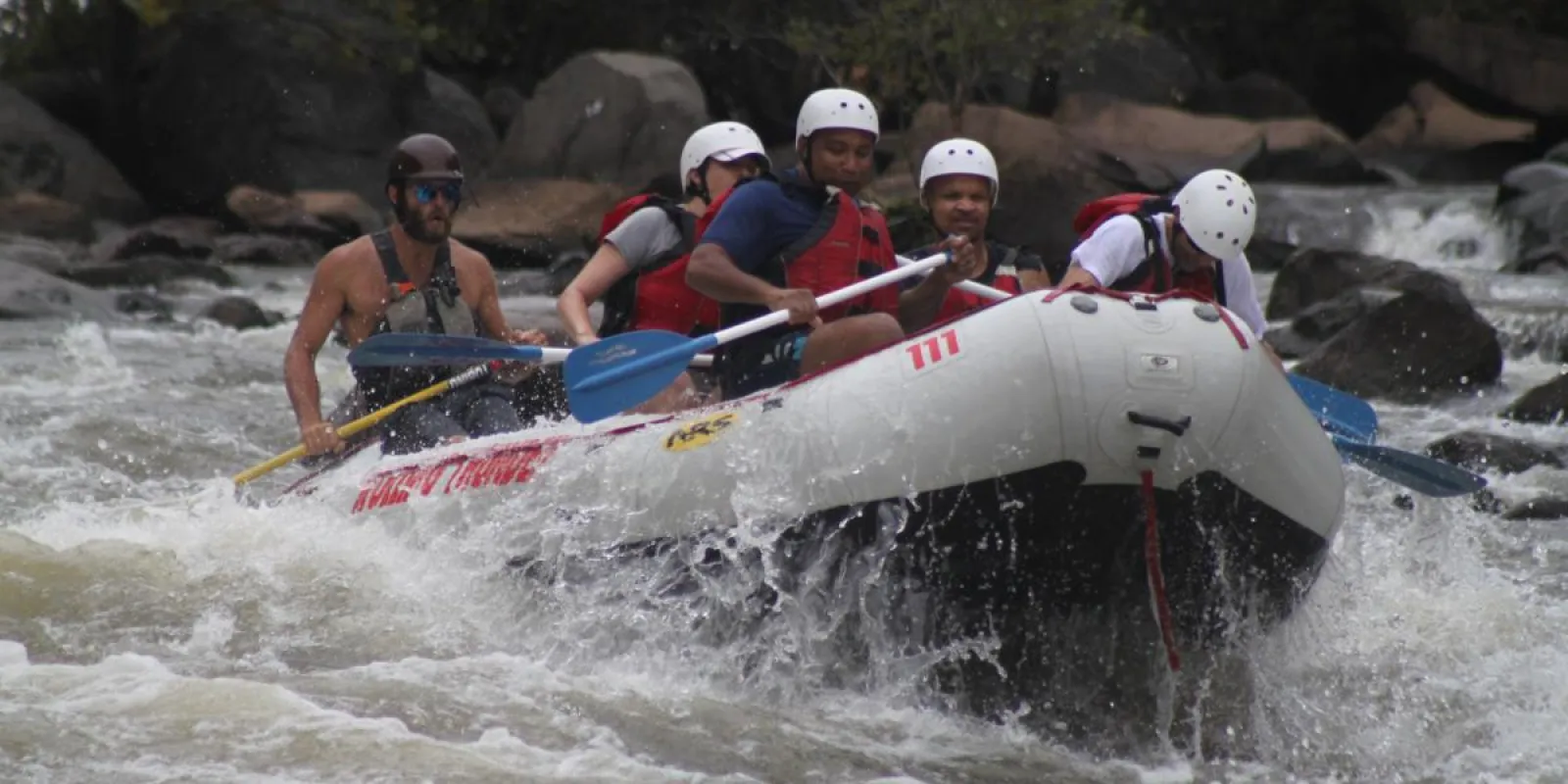 a group of people riding a river raft