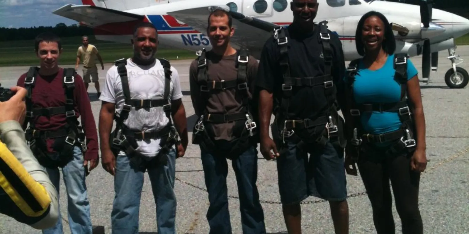 a group of people standing around a plane