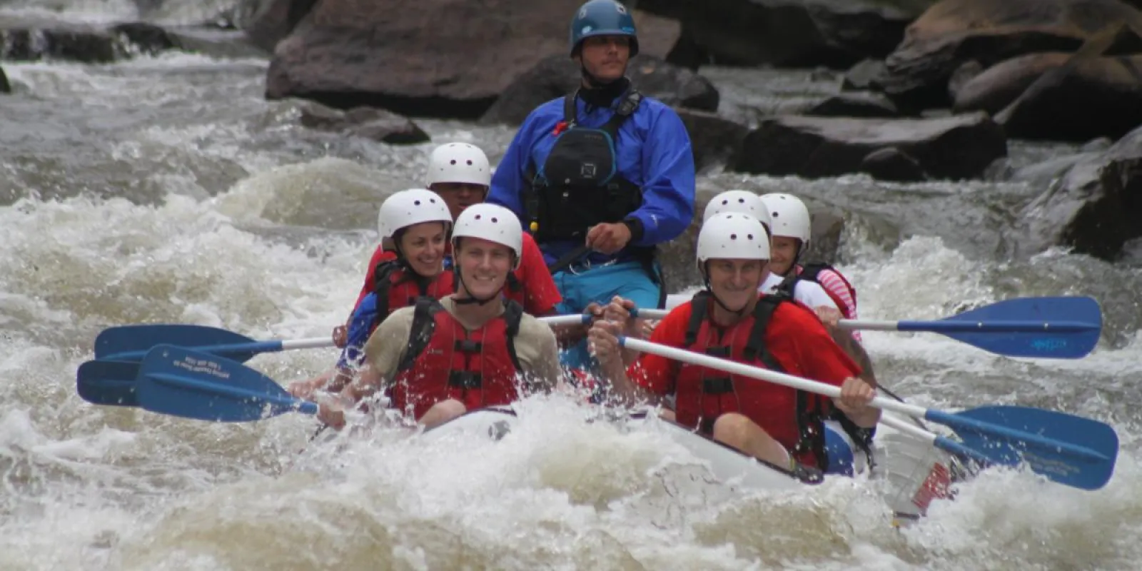 a group of people on a raft in the water