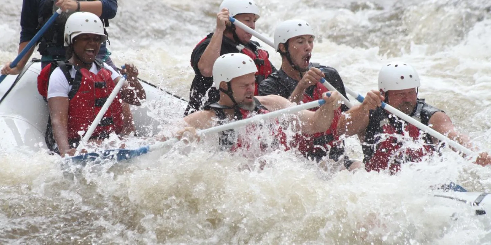 a group of people riding on a raft in a body of water