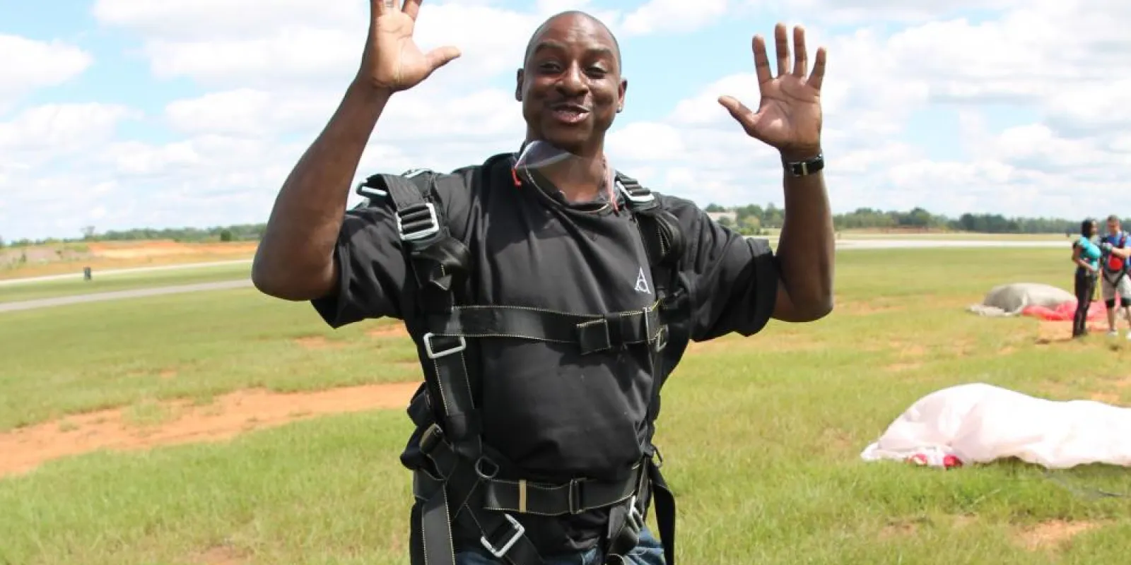 a man standing on top of a grass covered field