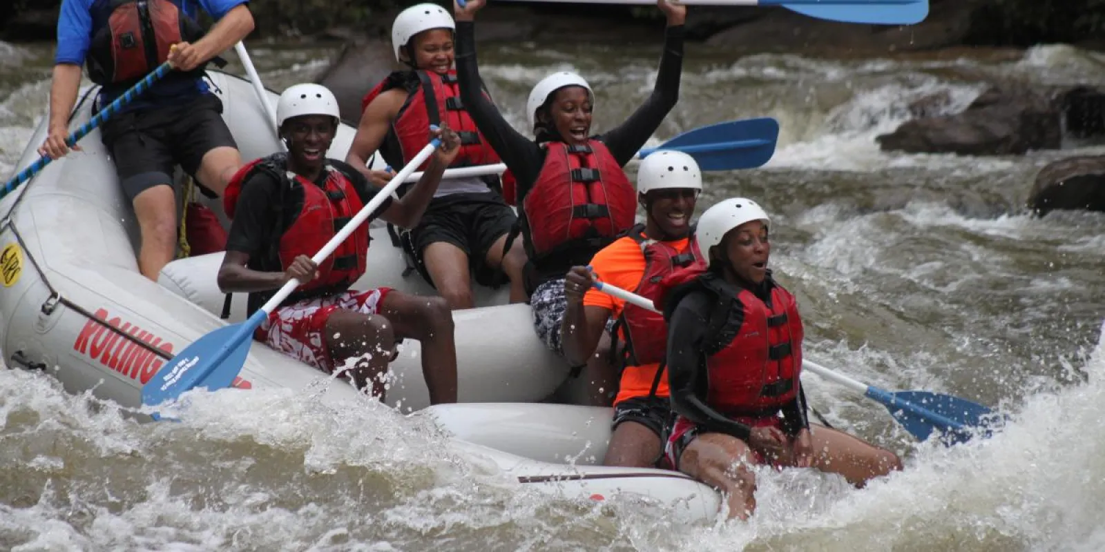 a group of people on a raft in the water